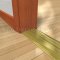 Pemko 253x3FG Bronze Mill Finish Threshold with Thermal Break on Wooden Floor