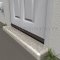 Pemko 345 Dark Bronze Rain Drip installed on the bottom of a door