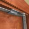 Pemko Z Bracket with 1/2" Backset in Gray Powder Coat applied to interior door