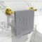 Emtek towel holder in gold finish with a towel installed in bathroom