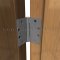 Ives 3CB1, Concealed Bearing, Full Mortise, Medium Weight, Brass Hinge on a Wooden Door